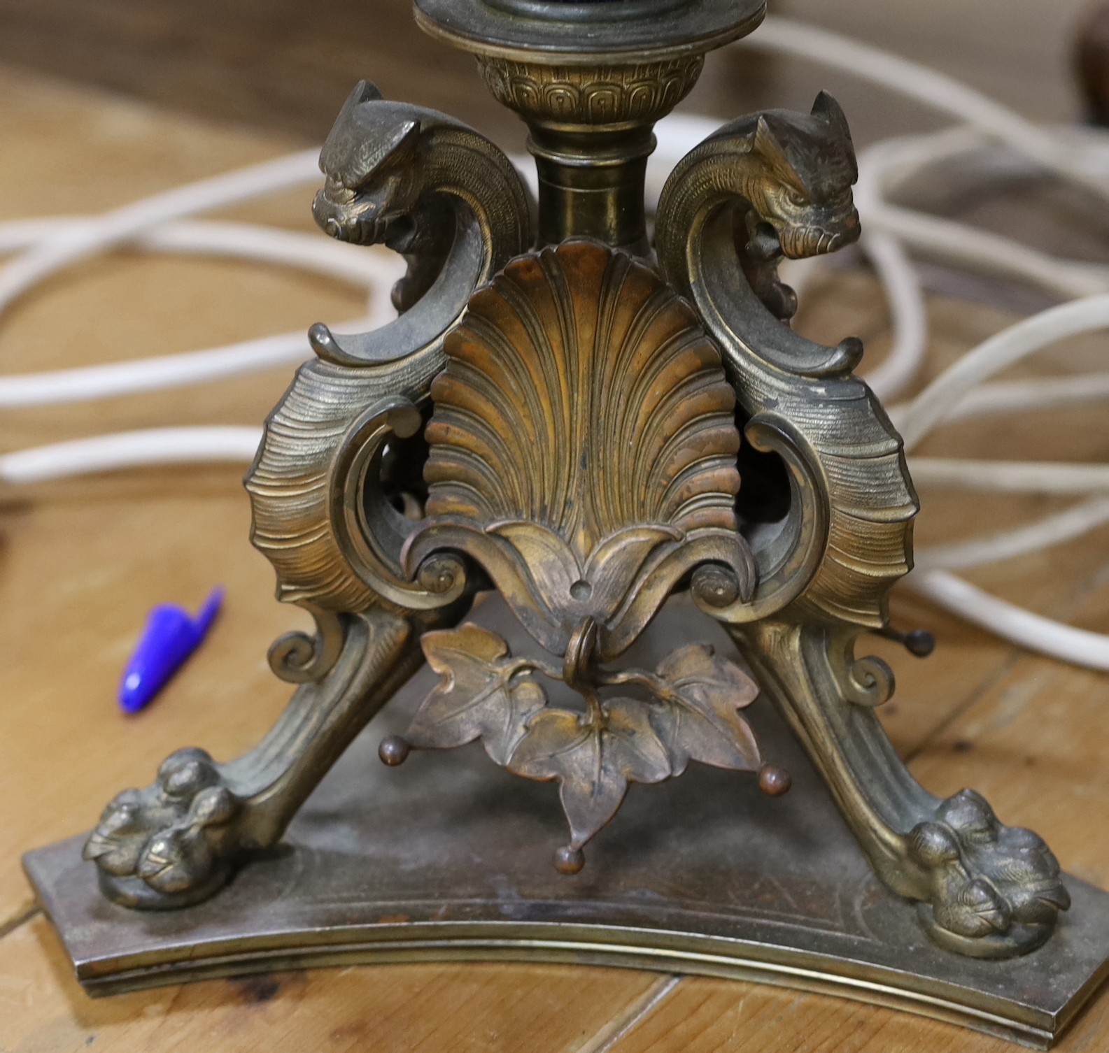 A pair of bronze table lamps, the bases cast with griffins and anthemion